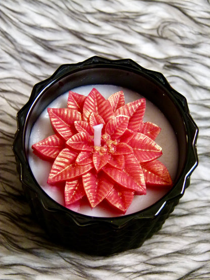 Bougie artisanale noire parfum Bulles Festives poinsettia rouge paillettes or contenant premium