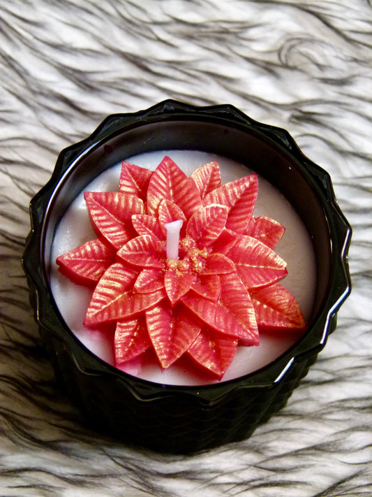 Bougie artisanale noire parfum Bulles Festives poinsettia rouge paillettes or contenant premium